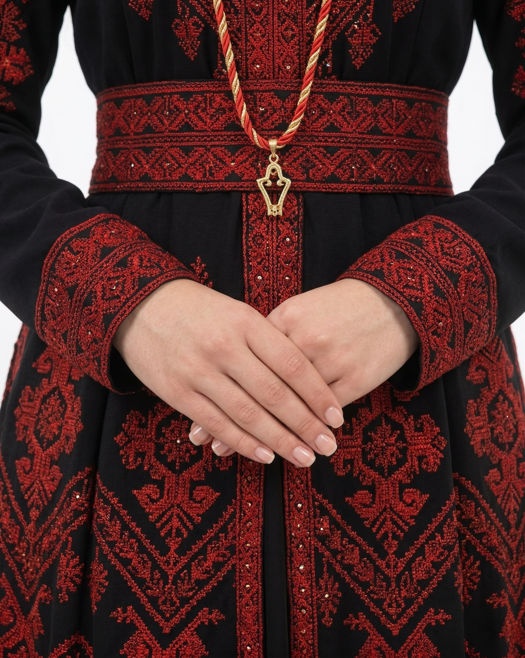 Alhaifawi | Traditional black and red embroidered garment with a decorative belt and pendant.